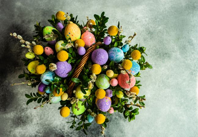 Top view of Easter basket with colorful decorative eggs