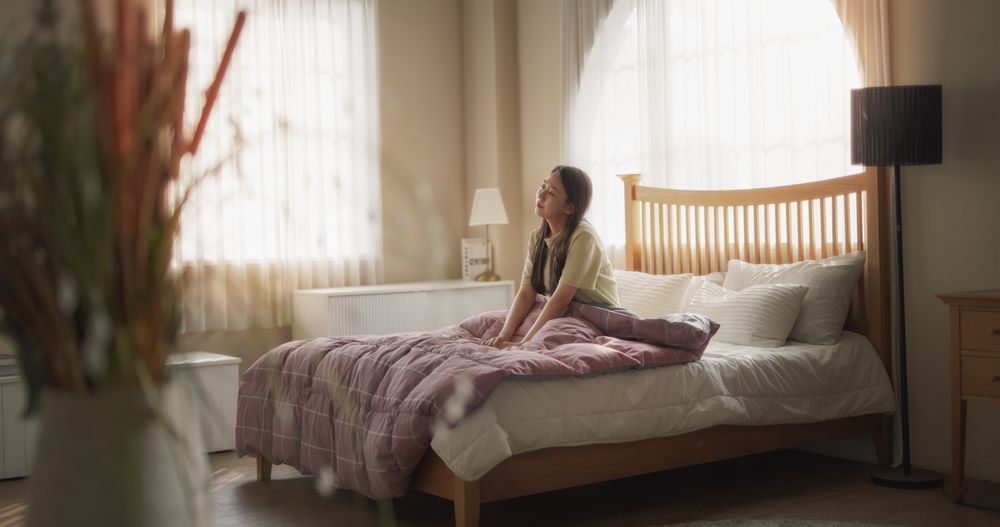 Young Asian Woman Waking up in the Morning