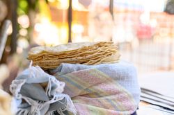 Stack of Mexican flatbreads on wrapped fabric
