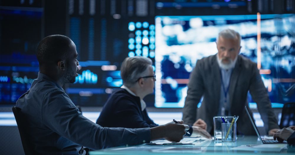 Diverse Group of Cybersecurity Experts Monitoring an Active Operation with Satellite Tracking Technology.