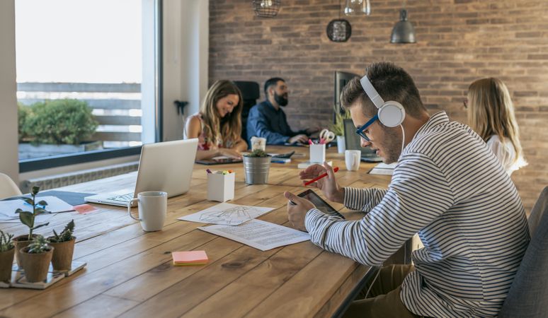 Man working with tablet and headphones in an office