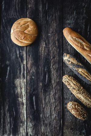 Assorted gold homemade bread on dark wood background
