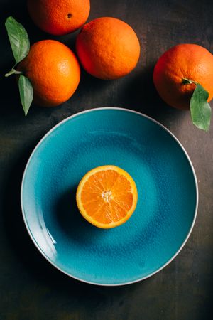 Fresh orange in a teal plate