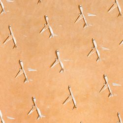 Rows of airplane partially submerged in sand