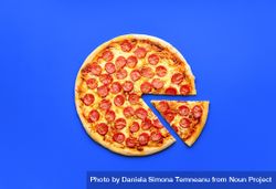 Homemade pepperoni pizza isolated on a blue background 4BymX5