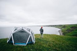 Back of man standing next to tent