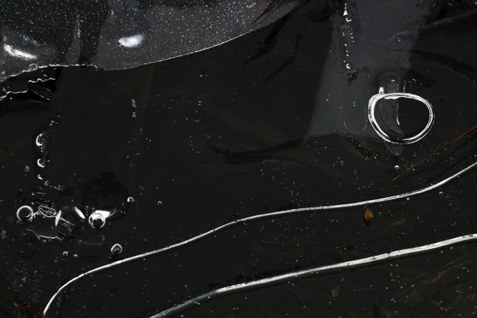 Fragment of thin ice on dark frozen river