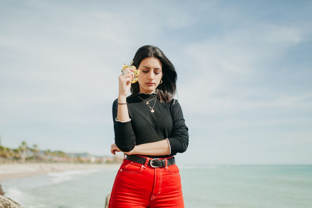 woman with flowers near to beach
