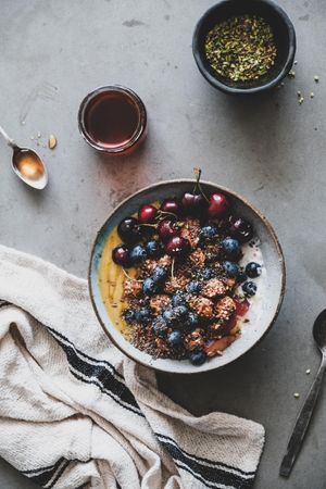 Oat granola yogurt bowl with cherries and blueberries