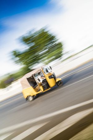Fast driving three wheeler on road