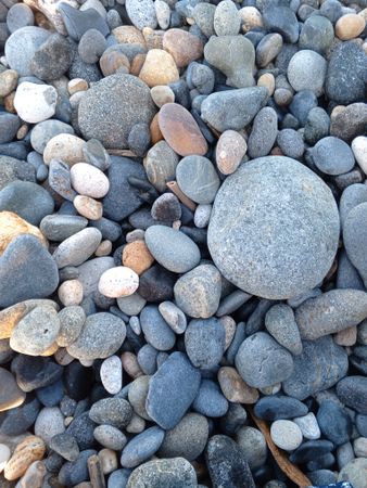 Rocks on a beach in Bengkulu, Indonesia, with gray tones and various patterns on the stones.