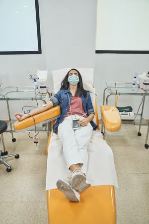 Female patient donating blood from vein
