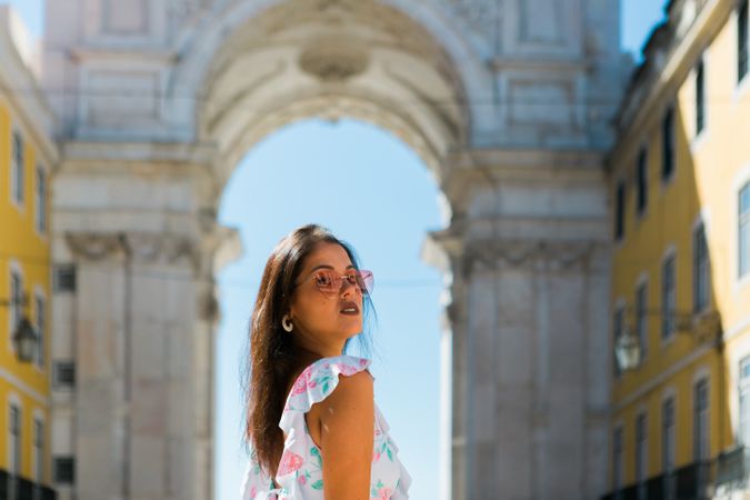 Woman showing standing near arch