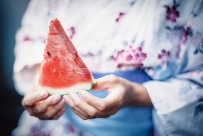 Woman wearing kimono holding watermelon