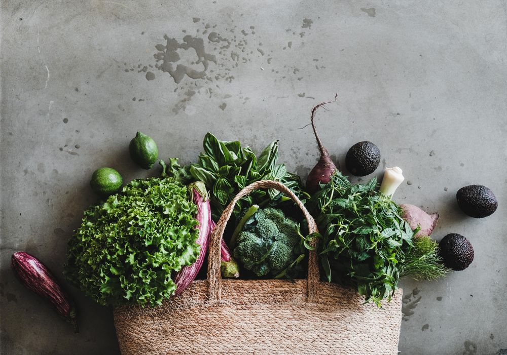 Jute bag with fresh produce, top view, horizontal composition, copy space