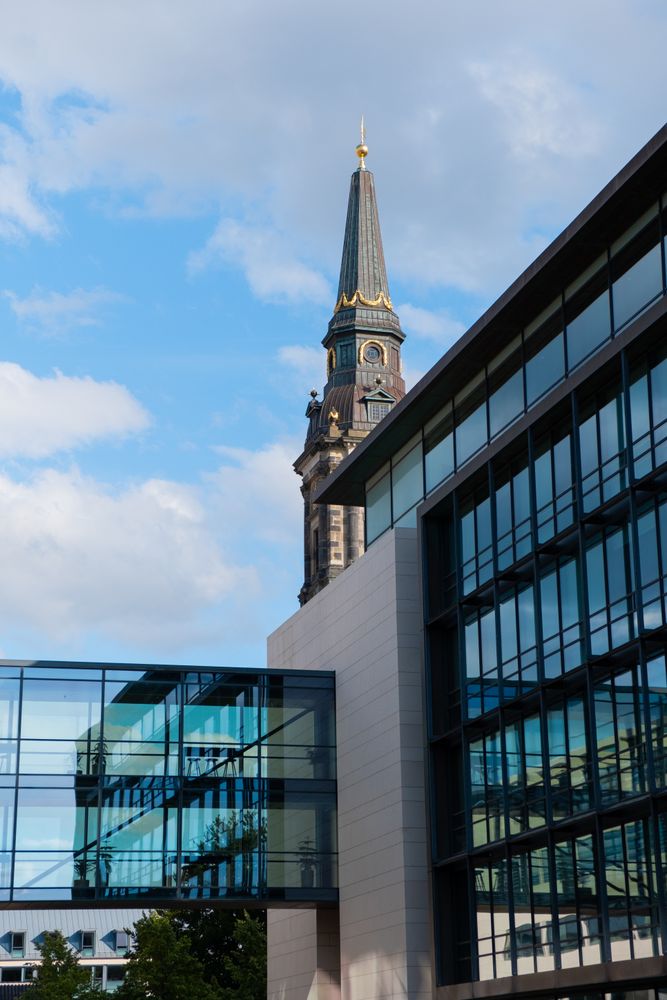 Walkway of corporate building with spire in background