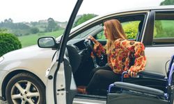 Woman in wheelchair leaving the car