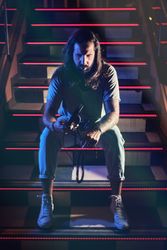 Man with headphones on steps in club