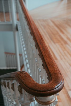 Dark wood railings of stairway