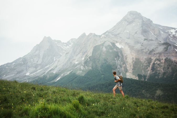 Unrecognizable man with backpack hiking in Pyrenees mountains