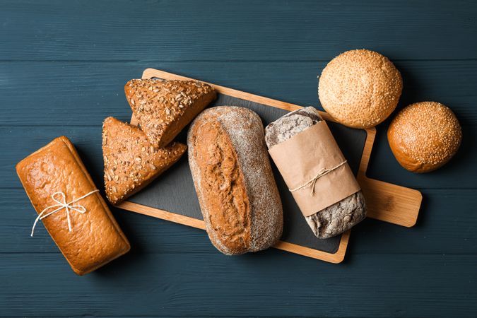 Flat lay composition with bakery products on wooden background, top view and space for text