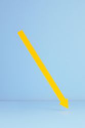 Yellow paper arrow over blue background