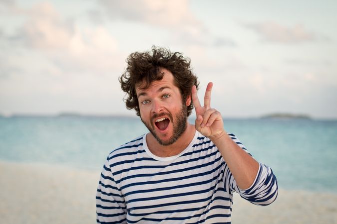 Man grimacing near sea