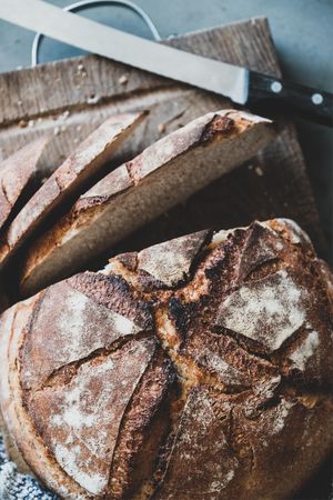 Freshly baked sourdough bread loaf, sliced, vertical composition, close up