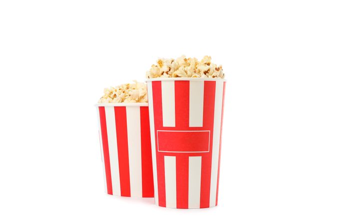 Striped buckets with popcorn isolated on plain background