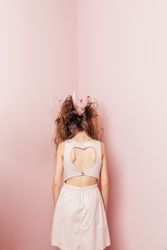 Back view of a young woman with hair tangled in furniture