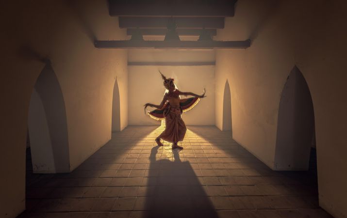 Silhouette of Thai person dancing in a hallway