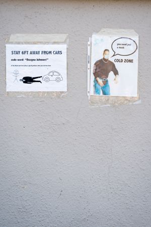 Safety signs at public testing site for coronavirus with graphics of Dwayne Johnson