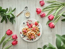 Sweet waffles amidst red tulips