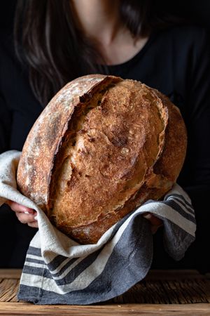 Crop person holding some bread
