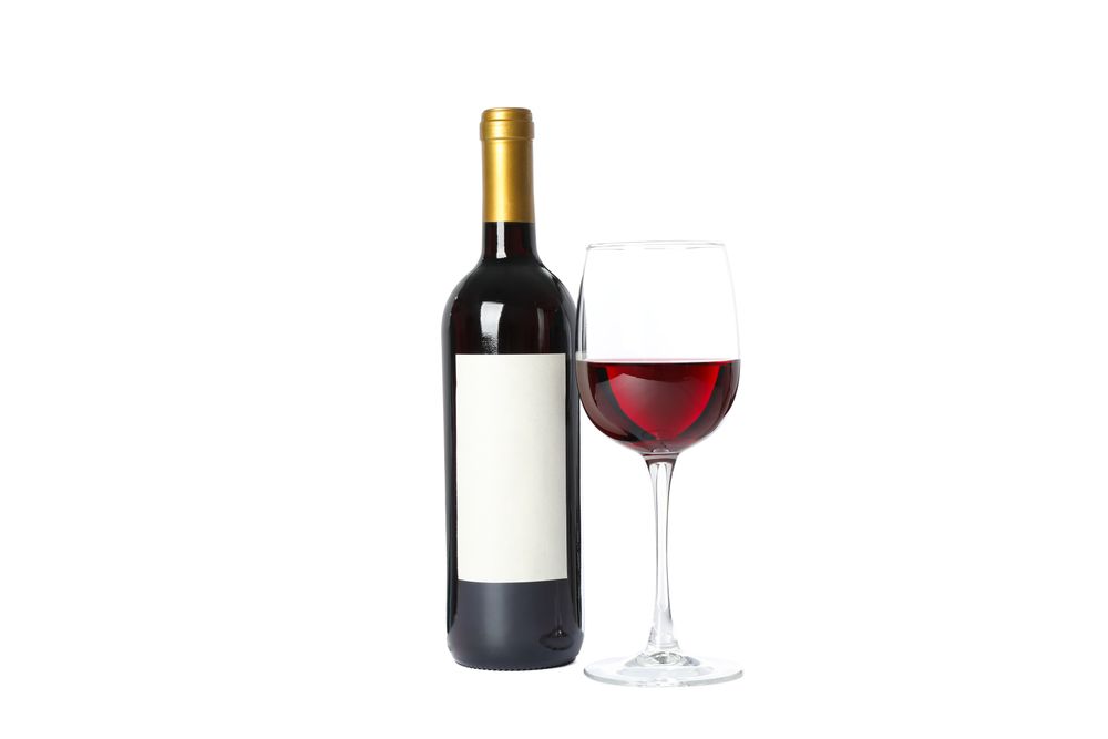 Bottle and glass with red wine isolated on blank background
