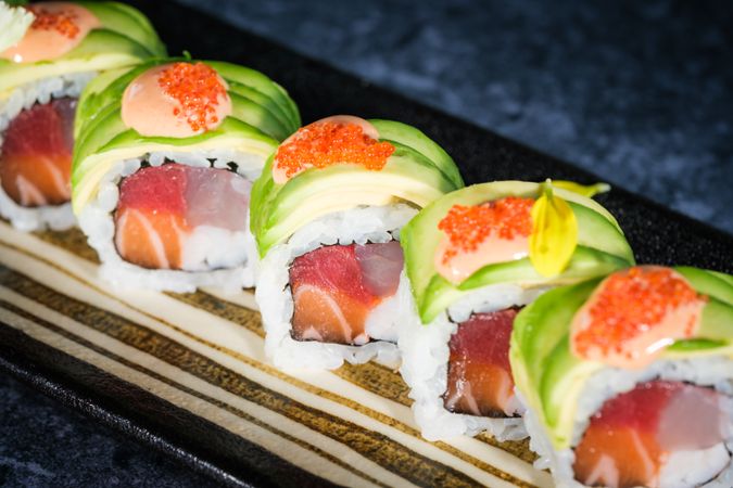 Delicious sushi rolls with avocado slices