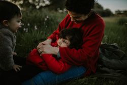 Mother with her young daughter and son in a park