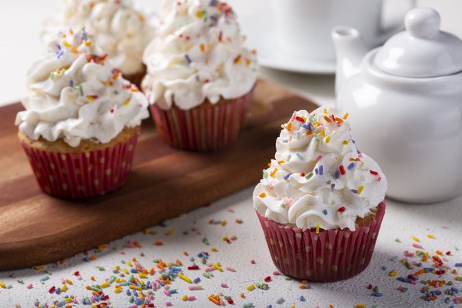 Tasty party cupcakes on the table. Cupcakes with whipped cream.