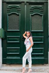 Confident stylish woman in sunglasses standing on city street