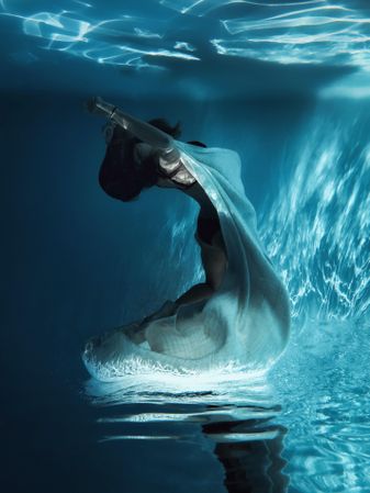 Underwater shot of woman in light dress