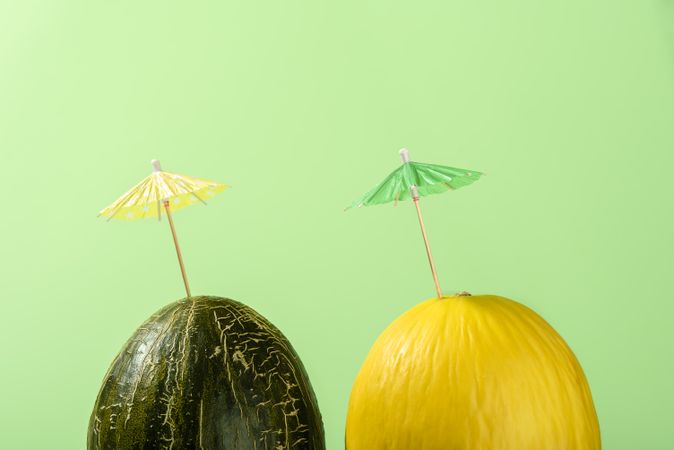 Two melons with cocktail umbrellas