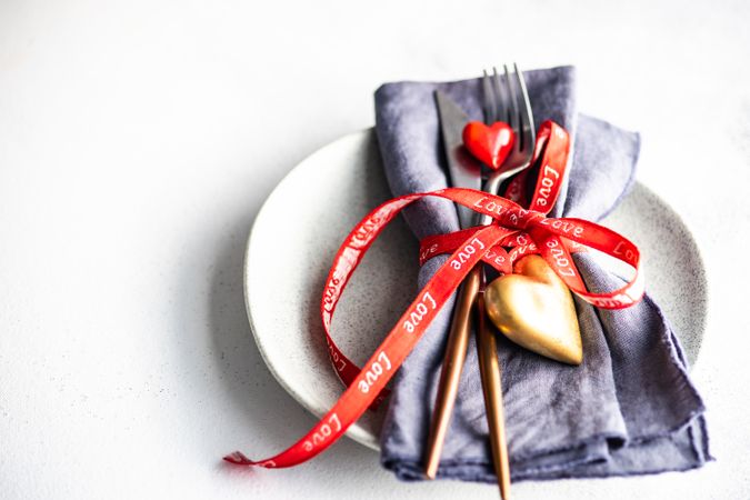 St. Valentine day concept of heart decorations and ribbon with cutlery