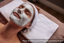 Woman with cosmetic face mask in spa 5XrXZG