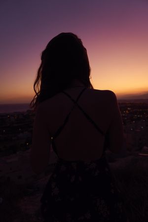 Silhouette of female enjoying picturesque sunset