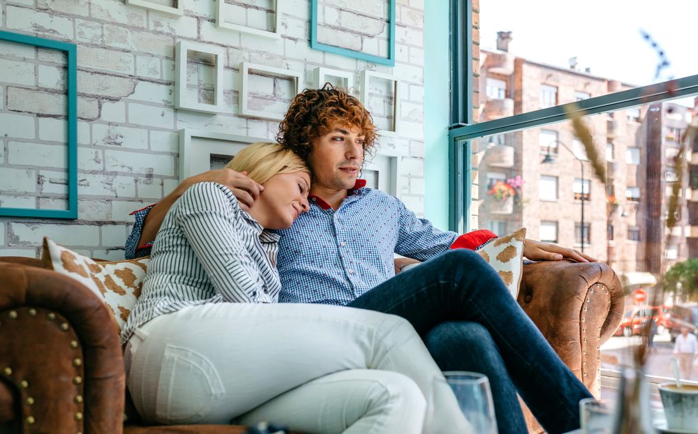 Couple hugging on a sofa