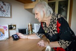 Woman adjusting smart meter