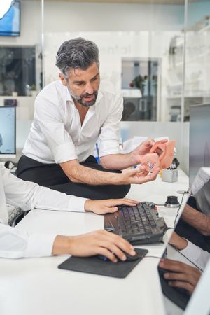 Man with printed facial mask in office