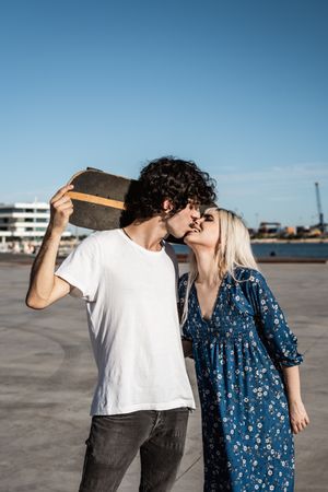 Trendy in love couple hugging on street