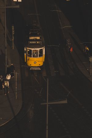 LISBON, PORTUGAL - JANUARY 23, 2019: Tramway on city street with pedestrians on sidewalk