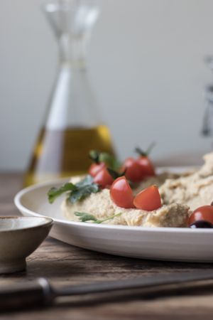 Pesto hummus with tomatoes and beans